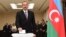 FILE - Azerbaijani President Ilham Aliyev casts his ballot at a polling station during a referendum in Baku, Azerbaijan, Sept. 26, 2016. 