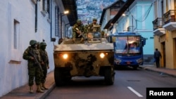 Soldiers patrol following an outbreak of violence a day after Ecuador's President Daniel Noboa declared a 60-day state of emergency following the disappearance of Adolfo Macias, leader of the Los Choneros criminal gang from prison, in Quito, Ecuador, Jan. 9, 2024. 