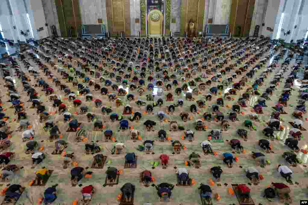 Muslims take part in congregational Friday prayers with social distancing measures in place due to the COVID-19 pandemic at a mosque in Surabaya, Indonesia.
