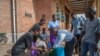 Parishoners wash hands as a preventive measure against the spred of the COVID-19 on the last day of full gatherings at the Saint Don Bosco Catholic Parish in Lilongwe, March 22, 2020.