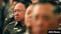 FILE - Thai policemen listen to Prime Minister Prayuth Chan-ocha delivering a speech at Government House in Bangkok, Thailand, April 3, 2015. 