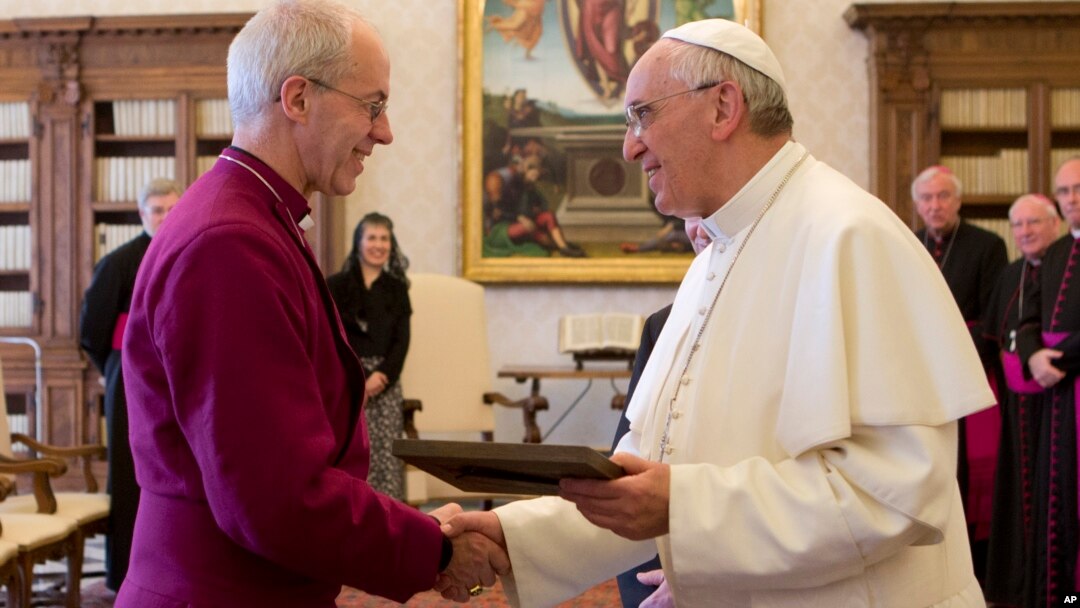Pope Francis exchanges gifts with the Archbishop of Canterbury, Justin Welby, during a private audience at the Vatican on June 14, 2013.