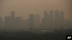 A thick layer of smog covers Lumpini Park in central Bangkok, Thailandy, Sept. 30, 2019. 