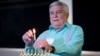 Rabbi Peter Tarlow lights a candle on a menorah during a Chicanukah event at the Holocaust Museum Houston, in Houston, Texas, Dec. 19, 2024.