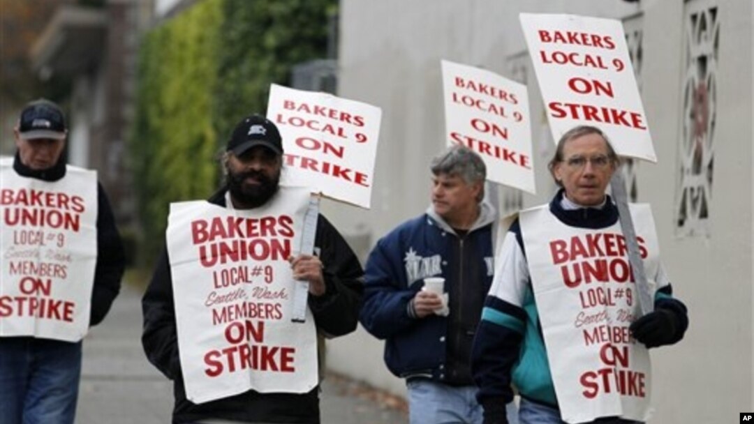 A small group of picketers from Bakery and Confectioners Workers Union Local 9 walk past a closed Hostess plant, Seattle, Nov. 16, 2012.