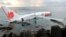 In this photo released by Indonesian Police, the wreckage of a crashed Lion Air plane sits on the water near the airport in Bali, Indonesia, April 13, 2013. 