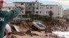 A swimming pool is dislodged and lays on a beach after storms undermined the pilings at Collaroy in Sydney, Monday, June 6, 2016.