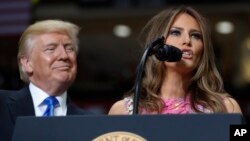 President Donald Trump looks to first lady Melania Trump as she introduces him during a rally at the Covelli Centre in Youngstown, Ohio, July 25, 2017.