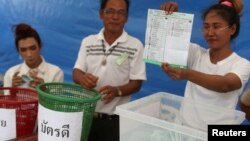 An electoral member shows a ballot during the vote counting, during the general election in Bangkok, Thailand, March 24, 2019. 