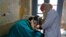 FILE - An elderly Kashmiri tuberculosis patient receives treatment at the Chest Disease Hospital on World Tuberculosis Day in Srinagar, India, March 24, 2015.