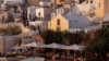 FILE - Tourists wait to view Santorini’s famed sunset, on Santorini, Greece, July 25, 2024. 