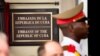 A member of the Cuban honor guard stands next to a new plaque at the front door of the newly reopened Cuban embassy in Washington, July 20, 2015. 