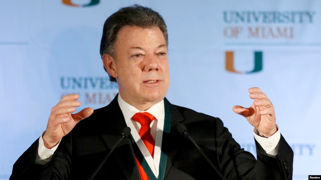 FILE - Colombia's President Juan Manuel Santos gestures as he addressed a gathering at the University of Miami in Coral Gables, Florida, Dec. 2, 2013. 