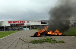 A bonfire is set outside Shoprite during a protest in Abuja, Nigeria, Sept. 4, 2019. South African-owned businesses operating in Nigeria are being targeted in retaliation for xenophobic attacks carried out against Africans working in South Africa.