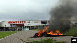 A bonfire is set outside Shoprite during a protest in Abuja, Nigeria, Sept. 4, 2019. South African-owned businesses operating in Nigeria are being targeted in retaliation for xenophobic attacks carried out against Africans working in South Africa.
