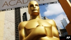 FILE - An Oscar statue appears outside the Dolby Theatre for the 87th Academy Awards in Los Angeles. The Academy of Motion Picture Arts and Sciences is trying to open access to the entertainment business for people from underrepresented communities. Academy Gold, an inclusive film academy internship program. which just wrapped its second summer, helps students learn the ropes of the entertainment business and get a foot in the door before college graduation.