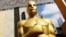 FILE - An Oscar statue appears outside the Dolby Theatre for the 87th Academy Awards in Los Angeles. The Academy of Motion Picture Arts and Sciences is trying to open access to the entertainment business for people from underrepresented communities. Academy Gold, an inclusive film academy internship program. which just wrapped its second summer, helps students learn the ropes of the entertainment business and get a foot in the door before college graduation.