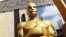 FILE - An Oscar statue appears outside the Dolby Theatre for the 87th Academy Awards in Los Angeles. The Academy of Motion Picture Arts and Sciences is trying to open access to the entertainment business for people from underrepresented communities. Acade