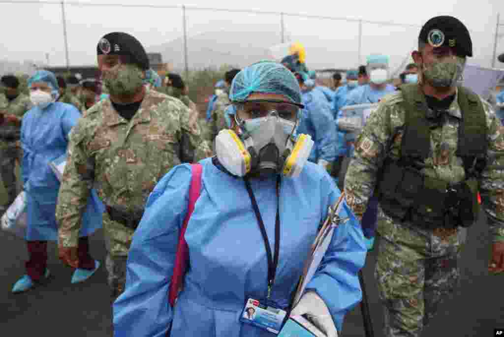 페루 리마에서 신종 코로나바이러스 방역 장비를 입은 의료진이 군인들의 보호를 받으면서 코로나 감염 방문 검사에 나섰다.