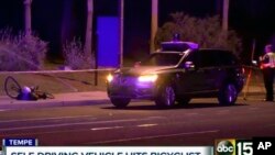 FILE - A still image taken from video provided by ABC-15, shows investigators at the scene of a fatal accident involving a self-driving Uber car on the street in Tempe, Arizona, March 19, 2018. 