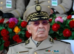 FILE - Algerian Gen. Ahmed Gaid Salah presides over a military parade at the Cherchell "Houari Boumediene" in Algiers, July 1, 2018.