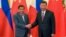 FILE - Philippine President Rodrigo Duterte, left, and Chinese President Xi Jinping pose for photographers on the sidelines of the Belt and Road Forum for International Cooperation at the Great Hall of the People in Beijing, May 15, 2017. 