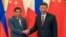 FILE - Philippine President Rodrigo Duterte, left, and Chinese President Xi Jinping pose for photographers on the sidelines of the Belt and Road Forum for International Cooperation at the Great Hall of the People in Beijing, May 15, 2017. 