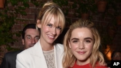 When actors January Jones, left, and Kiernan Shipka posed for this photo at the AMC Holiday Party in West Hollywood, California, on Nov. 13, 2014, a wide-eyed prankster photobombed them.