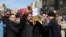 Mourners carry a coffin of prominent social activist Wissam al-Ghrawi in Basra, Iraq, Nov. 18, 2018. 