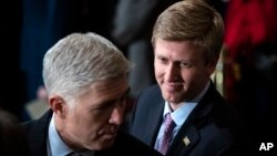 In a Monday, Dec. 3, 2018 file photo, Nick Ayers, right, listens as Supreme Court Associate Justice Neil Gorsuch waits for the arrival of the casket for former President George H.W. Bush to lie in State at the Capitol. 