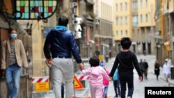 People walk during the lockdown, ahead of Italy's gradual lifting of restrictions which begins from May 4, due to the spread of the coronavirus disease (COVID-19), in Florence, Italy, May 1, 2020. 