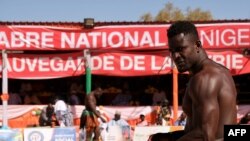 Traditional wrestlers prepare to fight during the National Sabre festival in Agadez, Niger, on December 31, 2023.