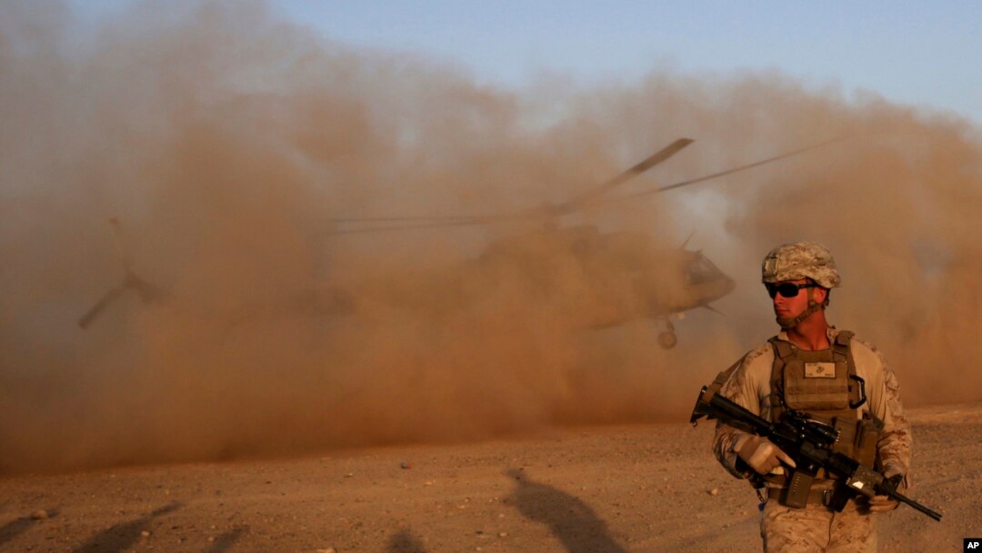 FILE - A U.S. Marine takes part during a training session for Afghan army commandos in Shorab military camp in Helmand province, Afghanistan, Aug. 27, 2017.