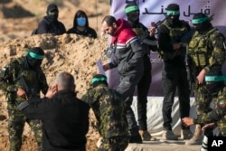 Israeli Yarden Bibas, 34, who has been held hostage by Hamas in Gaza since Oct. 7, 2023, is escorted by Hamas fighters before being handed over to the Red Cross in Khan Younis, southern Gaza Strip, Feb. 1, 2025.