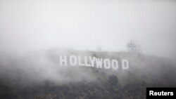 FILE: The Hollywood sign is seen through a mix of fog and dust snow during a rare cold winter storm in the Los Angeles area, in Los Angeles, California, on Feb. 24, 2023.