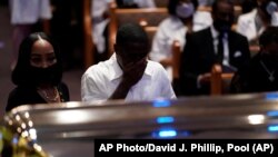 USA, Houston, Mourners pause by the casket of George Floyd during a funeral service for Floyd at The Fountain of Praise church