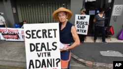 FILE - Anti-Adani coal mine protestor Rae Sheridan is seen outside the LNP (Liberal National Party) headquarters in Brisbane, April 11, 2019. The protestors are trying to stop the building of Adani's Carmichael coal mine. 
