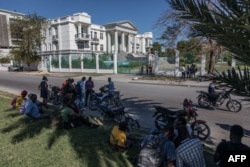 Journalists gather outside the Supreme Court of Haiti (Cours de cassation)on, Feb. 8, 2021 in the almost empty streets of Port-au-Prince.