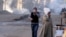 Egyptians react to tear gas fired by security forces to disperse a protest by supporters of ousted President Mohammed Morsi demanding his reinstatement, in Cairo, Egypt, Dec. 6, 2013. 