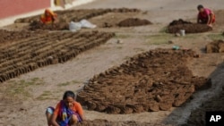 Seorang pekerja di India sedang membuat balok-balok dari kotoran sapi yang akan digunakan untuk bahan bakar. Di Kenya, sebuah perusahaan perusahaan sanitasi air, telah berhasil membuat bahan bakar yang sama dari kotoran manusia. (Foto:dok)