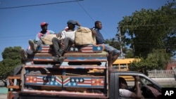 FILE - Commuters travel on a public transport vehicle known as a tap-tap in Port-au-Prince, Haiti, Aug. 5, 2023. Kenya, which established diplomatic relations with Haiti Wednesday, will lead an international police force aimed at combatting gang violence in the Caribbean nation. 