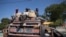 FILE - Commuters travel on a public transport vehicle known as a tap-tap in Port-au-Prince, Haiti, Aug. 5, 2023. Kenya, which established diplomatic relations with Haiti Wednesday, will lead an international police force aimed at combatting gang violence in the Caribbean nation. 