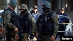 Heavily armed Macedonian police guard the premises of a court, during the final verdict for 37 people arrested and charged with terrorism-related offenses for clashes with Macedonian police in 2015 in Kumanovo, in Skopje, Macedonia, Nov. 2, 2017. 