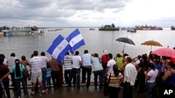 Người biểu tình tràn ra đường phố, ngăn chặn xe cộ trong lúc giơ hai tay lên trời tại Ferguson, Missouri, ngày 24/11/2014.