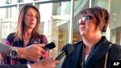 Michelle Balogh, right, and Kelly Willis speak to reporters Wednesday, Jan. 8, 2020 following the sentencing of the Mexican man who killed their brother, U.S. Border Patrol agent Brian Terry, in December 2010, outside court in Tucson, Ariz. 