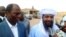 FILE: Ansar Dine Islamist group leader Iyad Ag Ghaly (R) speaks next to Burkina Faso's then-Foreign Minister Djibrille Bassole (L) on August 7, 2012 at the Kidal airport, northern Mali. 