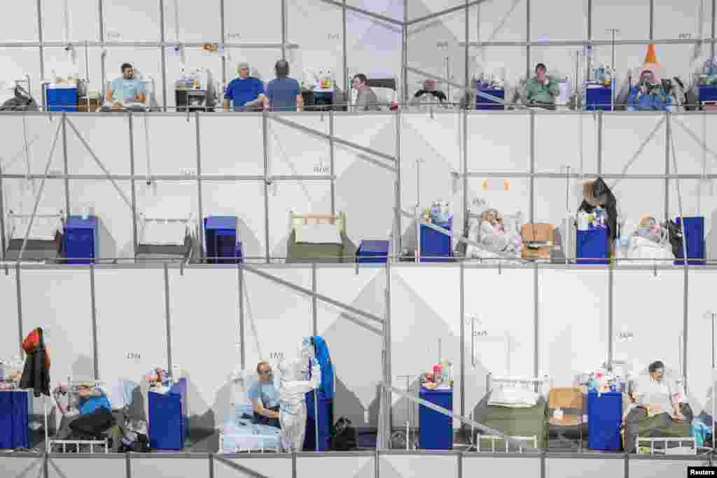 Patients suffering from the COVID-19 lay in beds at the Stark Arena sports venue that is turned into a COVID hospital in Belgrade, Serbia.