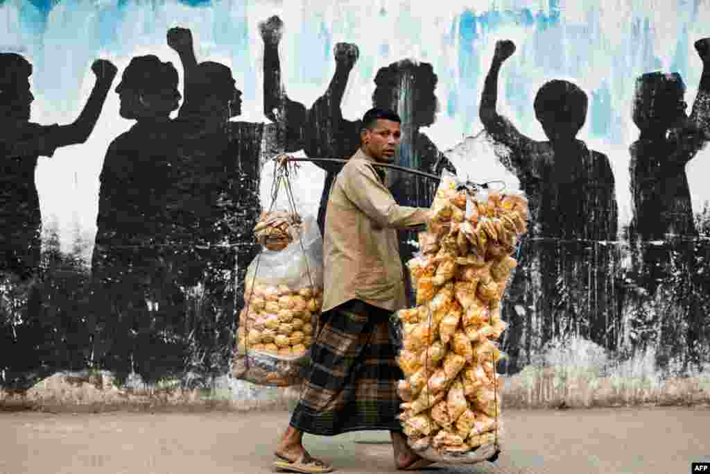 A vendor sells snacks on a street in Dhaka, Bangladesh.