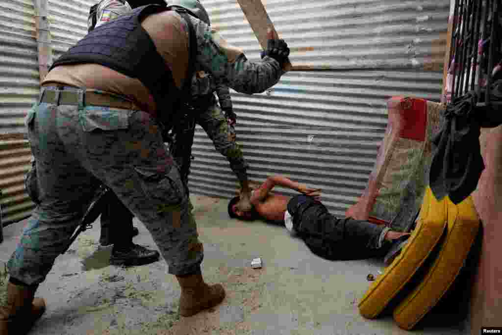 A man who was found smoking marijuana is beaten outside of his house by an Ecuadorean soldier outside his house on the outskirts of Guayaquil, in Duran, Ecuador, Oct. 16, 2024.