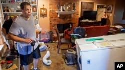 Raymond Lieteau takes photos his flood-damaged home in Baton Rouge, Louisiana, Aug. 16, 2016. Lieteau had more than five feet of water in his home. 